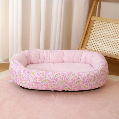 Panier-chien-coussin-4-saisons, 100% coton haute densité, ergonomique et rembourré, avec rebord surélevé épais à 360° pour un effet anti stress, entourant et enveloppant-coussin intérieur moelleux qui soutient et protège les articulations, lavable en machine et antidérapant-couchage pour chiot et chien de petite à moyenne taille de 0 à 15 kilos max-gros plan sur le modèle à fleurs et uni de couleur rose